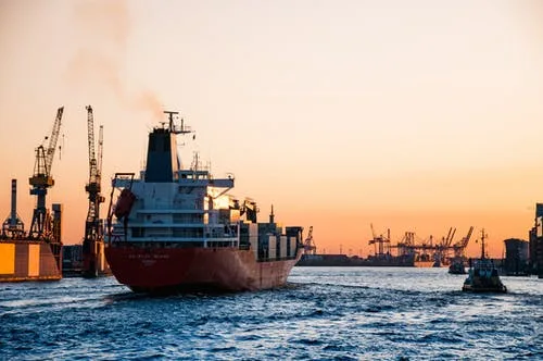 Container ship in a harbor at sunset