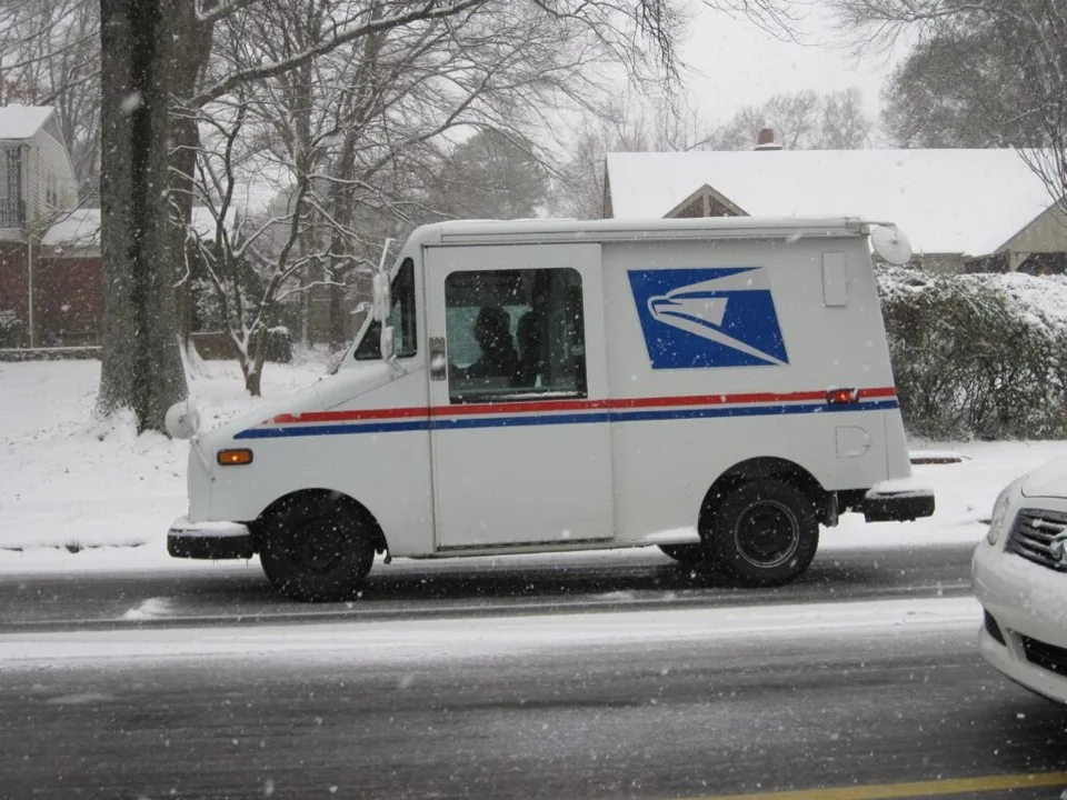 USPS delivery truck on a residential street
